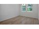 Dining room with wood-look flooring, natural light, and modern chandelier at 2992 Supermarine Rd, Tavares, FL 32778