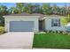 Charming one-story home boasts a two-car garage and well-manicured lawn, creating an inviting curb appeal at 2992 Supermarine Rd, Tavares, FL 32778