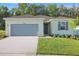 Charming one-story home boasts a two-car garage and well-manicured lawn, creating an inviting curb appeal at 2992 Supermarine Rd, Tavares, FL 32778