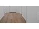 Hallway with attractive wood-look flooring and white trim at 2992 Supermarine Rd, Tavares, FL 32778