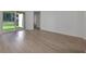 Bright living room featuring wood floors, sliding glass doors, and access to additional rooms at 2992 Supermarine Rd, Tavares, FL 32778