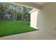 Covered patio is perfect for enjoying the backyard's lush greenery and serene natural views at 2992 Supermarine Rd, Tavares, FL 32778