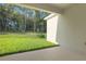 Covered patio is perfect for enjoying the backyard's lush greenery and serene natural views at 2992 Supermarine Rd, Tavares, FL 32778