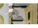 Aerial view of the home's roof, screened-in patio, and surrounding landscape at 320 Zingale Ln, The Villages, FL 32163