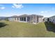 Expansive backyard with a sunroom and screened-in patio attached to home at 320 Zingale Ln, The Villages, FL 32163