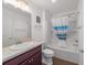 Well-lit bathroom with a shower-tub combo and a stylish wooden vanity at 320 Zingale Ln, The Villages, FL 32163