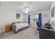 Comfortable bedroom featuring a daybed, a desk, and a window with blue curtains at 320 Zingale Ln, The Villages, FL 32163