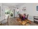 Bright dining area with sliding glass doors leading to the lanai and a view into the adjacent bedroom at 320 Zingale Ln, The Villages, FL 32163