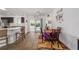 Open dining area featuring wood-look floors, access to the kitchen, and a view of the outdoor space at 320 Zingale Ln, The Villages, FL 32163