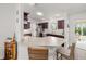 Cozy kitchen showcasing dark wood cabinets, stainless appliances, breakfast bar, and access to the screened-in lanai at 320 Zingale Ln, The Villages, FL 32163