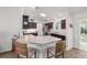 Bright kitchen featuring wood cabinets, stainless appliances, a breakfast bar with seating, and sliding door access to the patio at 320 Zingale Ln, The Villages, FL 32163