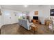 Cozy living room with wood floors, a comfortable sofa, and an entertainment center with a television at 320 Zingale Ln, The Villages, FL 32163