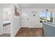Bright living room featuring a large window, wood-look floors, and a glimpse into the adjacent bedroom at 320 Zingale Ln, The Villages, FL 32163