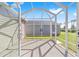 Screened-in patio offering a view of the home's spacious backyard at 320 Zingale Ln, The Villages, FL 32163