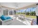 Bright sunroom featuring many windows, tiled floors, and ceiling fan at 320 Zingale Ln, The Villages, FL 32163