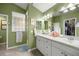 Double vanity bathroom with a separate shower and glass block feature at 3248 Killington Loop, The Villages, FL 32163