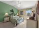 Spacious bedroom with a ceiling fan and leafy patterned bedding at 3248 Killington Loop, The Villages, FL 32163