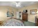 Bright bedroom with wood furniture and access to other rooms at 3248 Killington Loop, The Villages, FL 32163