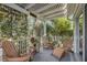 Relaxing covered porch with wooden chairs, offering a peaceful outdoor sitting area at 3248 Killington Loop, The Villages, FL 32163
