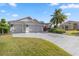 Attractive curb appeal with a two-car garage and manicured lawn at 3248 Killington Loop, The Villages, FL 32163