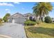 Beautiful one-story home with a two-car garage and lush landscaping at 3248 Killington Loop, The Villages, FL 32163