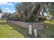Landscaped side yard with retaining wall and lush greenery at 3248 Killington Loop, The Villages, FL 32163