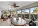 Bright sunroom with plenty of seating and large windows at 3248 Killington Loop, The Villages, FL 32163