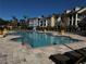 Resort-style pool with lounge chairs and surrounding apartment buildings at 3615 Conroy Rd # 614, Orlando, FL 32839