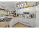 Well-equipped kitchen with white cabinets and modern appliances at 3615 Conroy Rd # 614, Orlando, FL 32839