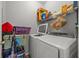 Laundry room with washer, dryer, and shelving at 3615 Conroy Rd # 614, Orlando, FL 32839
