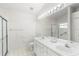 Clean bathroom, double vanity, and a walk-in shower at 3806 Doune Way, Clermont, FL 34711