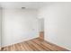 Spacious bedroom featuring wood-look floors and an open door to another room at 3806 Doune Way, Clermont, FL 34711