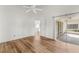 Spacious bedroom with wood-look floors and access to a patio at 3806 Doune Way, Clermont, FL 34711