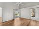 Bedroom with wood floors, backyard access, and large window at 3806 Doune Way, Clermont, FL 34711