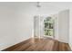 Bright bedroom with wood flooring and an arched window at 3806 Doune Way, Clermont, FL 34711