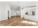 Dining room with chandelier, wood floors and view to kitchen at 3806 Doune Way, Clermont, FL 34711