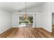 Sunlit dining area with wood floors and access to patio at 3806 Doune Way, Clermont, FL 34711