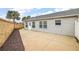 Private backyard with a large patio and neutral colored siding at 4056 Venetian Ln, The Villages, FL 32163