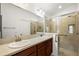 Bathroom features a double vanity, large mirror, and a walk-in shower at 4056 Venetian Ln, The Villages, FL 32163