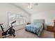 Spacious bedroom with a bed, exercise bike and plenty of natural light at 4056 Venetian Ln, The Villages, FL 32163