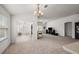 Bright dining room features a large table with white chairs, chandelier, and access to living room at 4056 Venetian Ln, The Villages, FL 32163