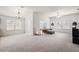 Bright dining room features a large table with white chairs, chandelier, and access to living room at 4056 Venetian Ln, The Villages, FL 32163