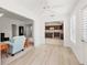 Open living room with light flooring and views into the kitchen at 4056 Venetian Ln, The Villages, FL 32163