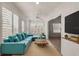 Relaxing sunroom features a teal sectional sofa and a wooden coffee table at 4056 Venetian Ln, The Villages, FL 32163