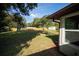 Expansive backyard features a wooden fence, storage shed, and play set for outdoor enjoyment at 4566 County Road 116, Wildwood, FL 34785