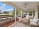 Screened porch with seating area, ceiling fan and view of the backyard at 5312 Galley Way, Oxford, FL 34484