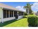 Charming home with screened porch, lush lawn, and mature landscaping at 546 Foxfield Path, The Villages, FL 32162