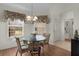 Breakfast nook featuring a glass table, bright windows, and decorative window treatment at 546 Foxfield Path, The Villages, FL 32162