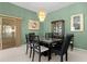 Elegant dining room with a glass-top table and matching chairs at 546 Foxfield Path, The Villages, FL 32162