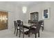 Elegant dining room featuring dark wood table and chairs with a crystal chandelier, perfect for Gathering gatherings at 546 Foxfield Path, The Villages, FL 32162